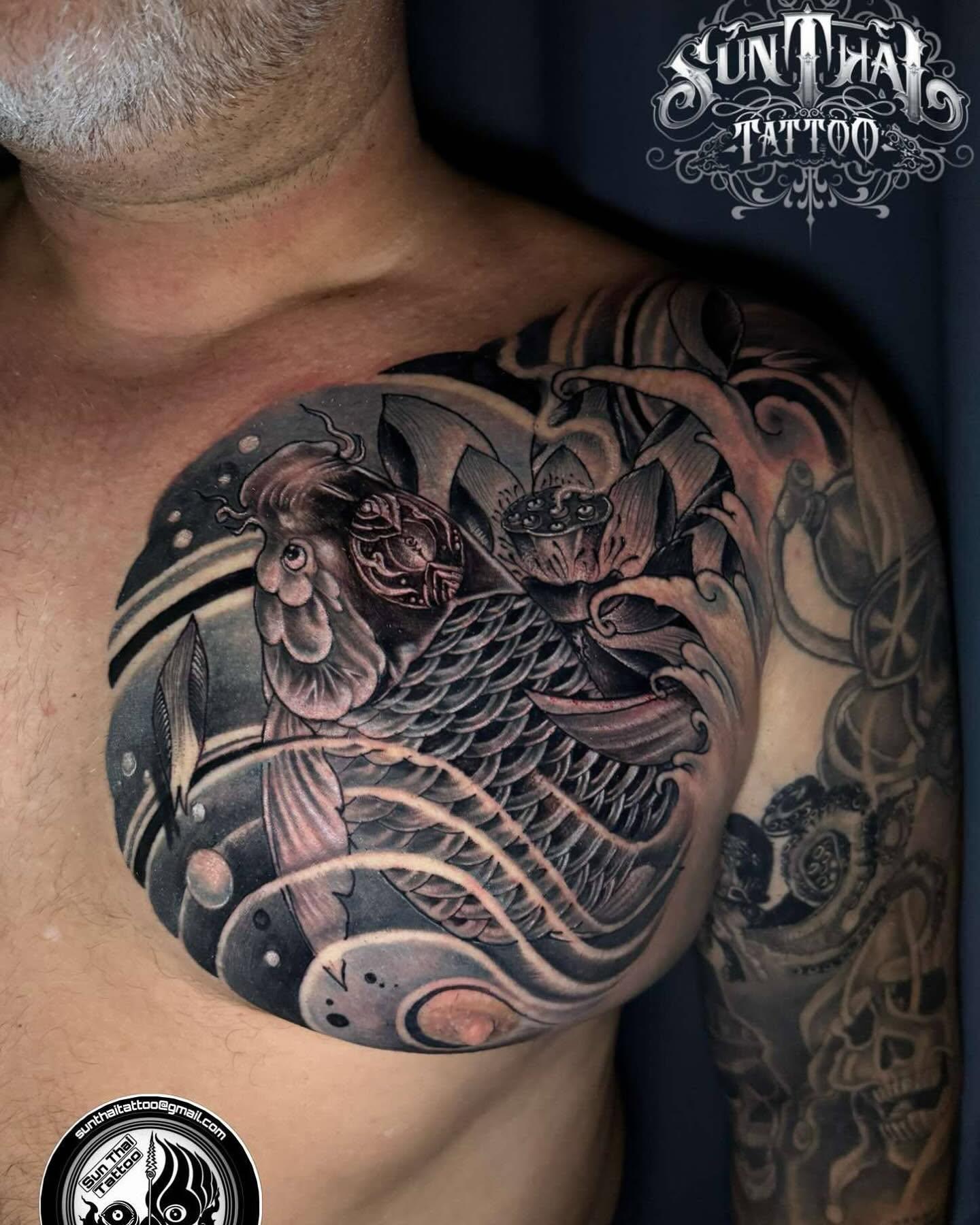 Black and grey koi chest tattoo