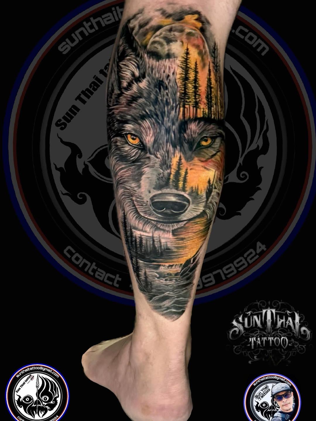 Realistic wolf and forest colour leg tattoo